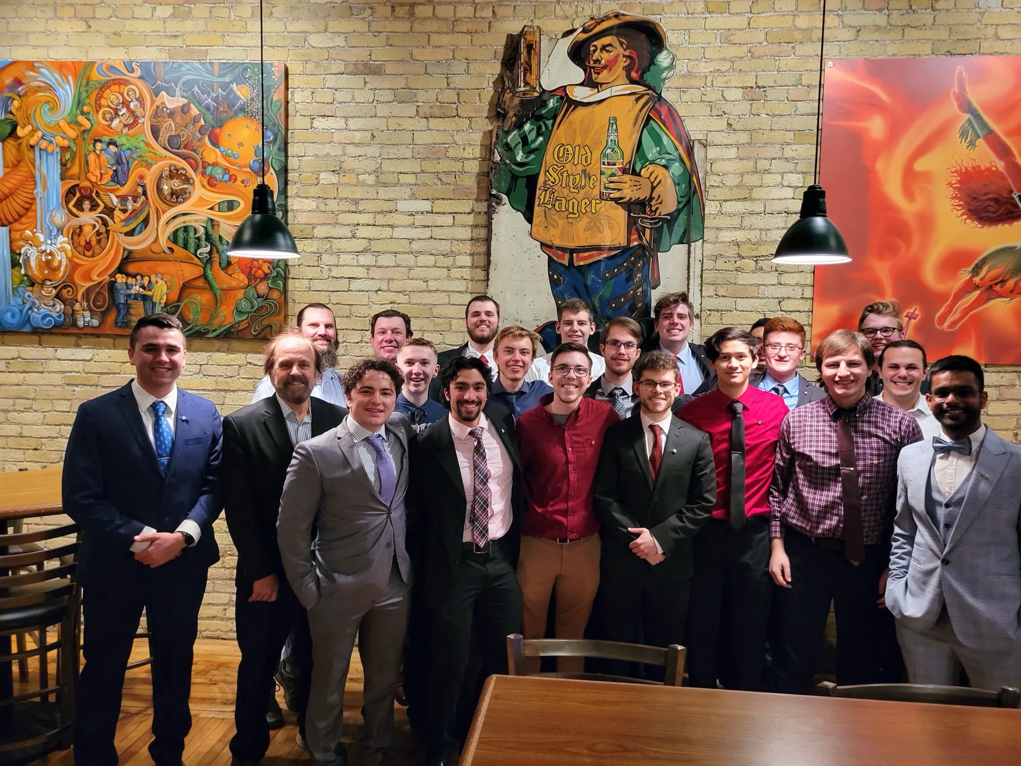 Active members and alumni of MSOE Triangle in suits at a chapter dinner