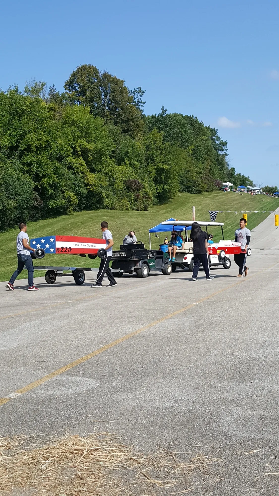 Members moving derby cars along the track at the New Berlin Boxcar Derby